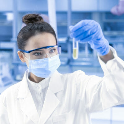 Female scientist looking at scientific sample in lab
